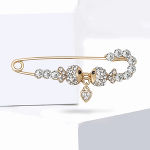 Elegant gold-tone twin fish brooch with heart pendant and sparkling rhinestones