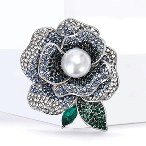 Elegant camellia flower brooch with blue crystal petals and a large pearl center