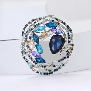 Exquisite crystal bird nest brooch with deep blue centerpiece and silver alloy base