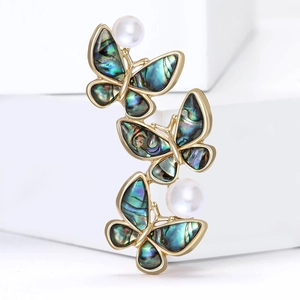 Elegant gold butterfly brooch with iridescent abalone shell wings and white pearls