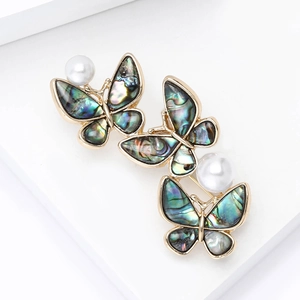Elegant gold butterfly brooch featuring iridescent abalone shell wings and white pearls