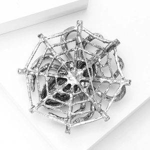 Detailed back view of vintage silver spider web brooch with secure metal pin clasp
