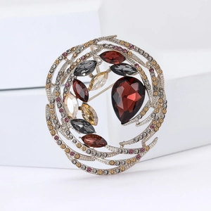 Macro detail of vintage bird nest brooch with colorful crystals on silver metal rings