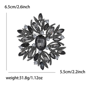Detail showing vintage snowflake brooch dimensions of 6.5cm by 5.5cm on white background