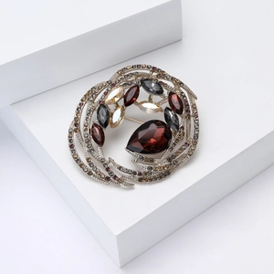 Macro shot of bird nest crystal brooch with pear-shaped gems and silver finish