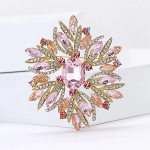 Macro detail of the alloy rhinestone brooch with pink oval crystal and gold plating