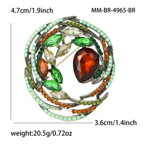 Vintage bird nest crystal brooch with green and amber stones on antiqued metal base