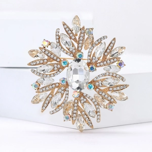 Detail view of flower brooch with oval crystal and marquise rhinestones in gold setting