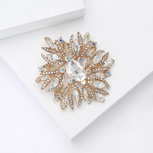 Macro detail of luxury starburst brooch with oval gemstone and sparkling marquise crystals