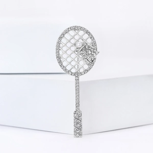 Elegant silver tennis racket brooch with sparkling rhinestones and white pearl accent