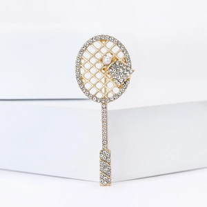 Creative tennis racket brooch with sparkling rhinestones and white pearl on gold alloy
