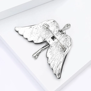 Detailed back view of vintage silver angel wing brooch with secure metal pin clasp