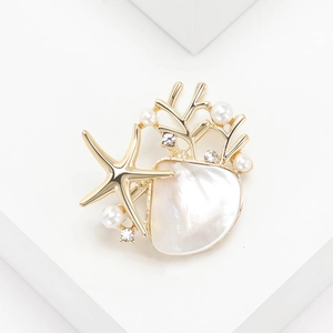 Elegant gold starfish and seashell brooch with white pearls and sparkling rhinestones
