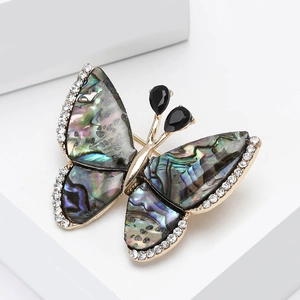Élégante broche papillon avec ailes en nacre d'abalone naturelle et strass brillants
