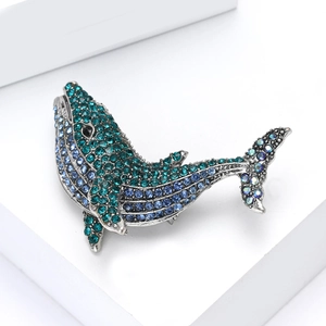 Detailed view of whale brooch with gradient blue rhinestones and silver metal finish