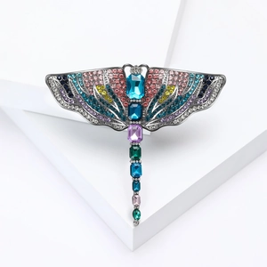Elegant dragonfly brooch with colorful crystals and rhinestones on dark metal frame