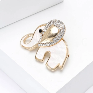 Elegant gold elephant brooch with iridescent white shell inlay and sparkling rhinestones