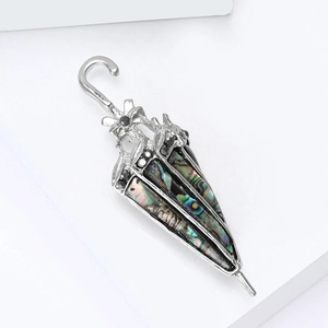 Elegant silver umbrella brooch with iridescent abalone shell inlay and black diamond accents