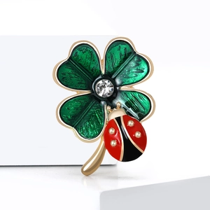 Charming enamel clover and ladybug brooch with sparkling rhinestone and golden accents