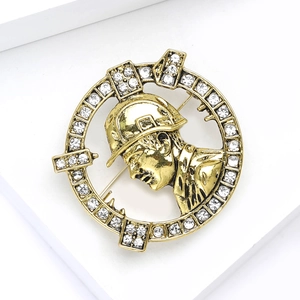 Macro detail of a vintage gold badge brooch with rhinestones and helmeted figure