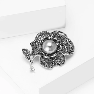 Elegant vintage gunmetal flower brooch with dark rhinestones and a large grey pearl inlay