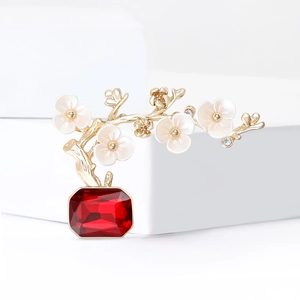Elegant plum blossom bonsai brooch with pearl-like petals and ruby red gemstone detail