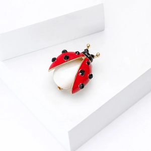 Classic ladybug brooch with red enamel wings, black rhinestones and white opal stone