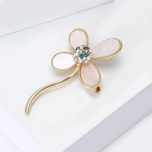Elegant four-leaf clover brooch with pink mother-of-pearl petals and gold accents
