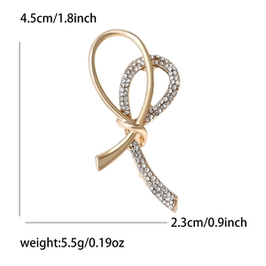 Elegant gold-tone knot brooch with sparkling rhinestones and size measurements