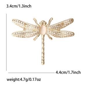 Golden dragonfly brooch with hollow wings, cat eye stone, and detailed size dimensions