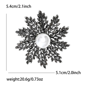 Broche flocon de neige vintage avec strass noirs et perle blanche centrale