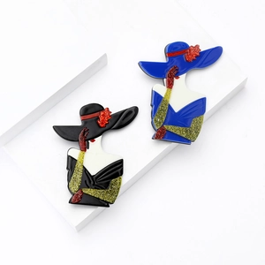 Vintage acrylic Marilyn Monroe style brooches in black and blue with glittery details