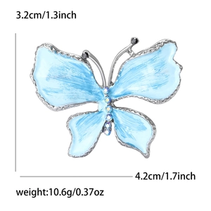 Spilla a farfalla in smalto blu con cristalli, misura 3,2 cm di altezza per 4,2 cm di larghezza