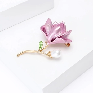Elegant pink enamel tulip brooch with white pearl and gold plating on a white pedestal