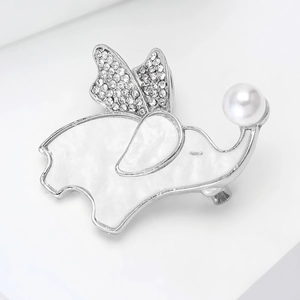 Macro detail of elephant brooch with shell inlay, shimmering crystals and white pearl