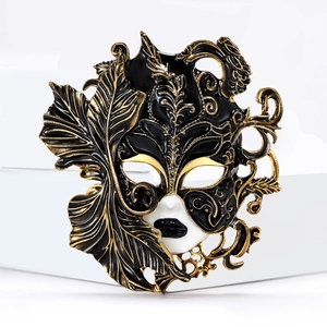 Detailed close-up of a luxury enamel Venetian mask brooch with gold ornate scrollwork