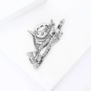 Silver metal brooch back showing detailed pin closure mechanism and hollow design details