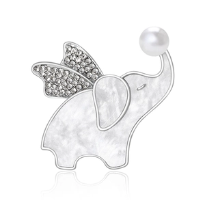 Cute flying elephant brooch with pearl and crystal wings on a white background