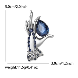 Vintage silver brooch hand holding large blue teardrop gemstone with size markings