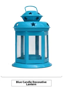 Blue metal Christmas candle lantern with star cutouts and glass panels for home decor