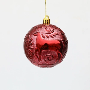 Red Christmas ball ornament with embossed reindeer and scroll patterns for tree decor