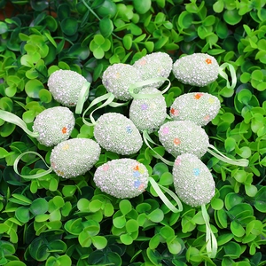 Set of 12 speckled Easter egg ornaments with floral details and green hanging ribbons