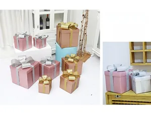 Close-up of assorted Christmas gift boxes with glitter bows in pink and champagne gold tones