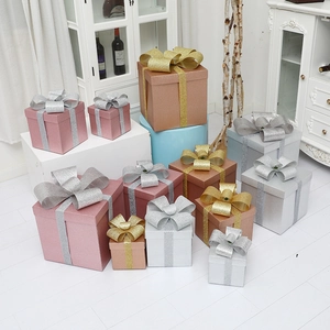 Sparkly multi-color Christmas gift boxes with ribbons for festive holiday tree decoration