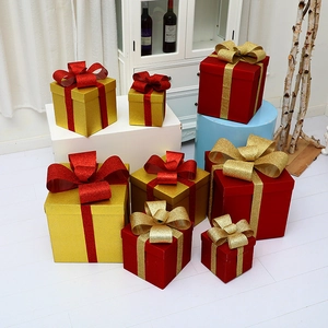 Christmas tree gift boxes set with red and gold glitter ribbons for holiday decorations