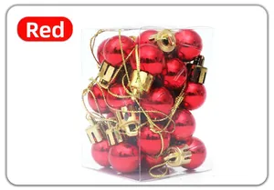 Close-up of 24 red Christmas balls with gold strings in a clear rectangular plastic box
