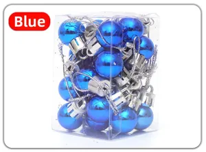 Detail of 24-piece blue shiny Christmas tree ornaments in a transparent gift box