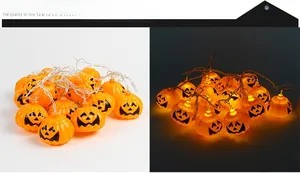 Detail of Halloween pumpkin LED string lights showing unlit and warm glowing modes