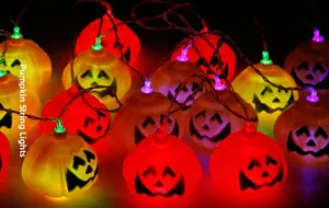 Close-up of vibrant LED Halloween pumpkin string lights with colorful glowing expressions