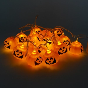 Halloween LED pumpkin string lights with warm orange glow and spooky hollow expressions